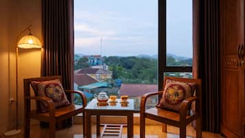 Family Triple Room, Multiple Beds, Air conditioning, Garden View | In-room dining