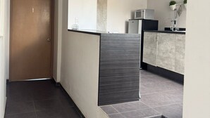 A modern interior with a staircase, a kitchen area, and a ceiling fan. - Room with private bathroom in providencia (Guadalajara)