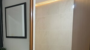 A bathroom with a white sink, a framed mirror, a toilet, and a potted plant. - Room with private bathroom in providencia (Guadalajara)