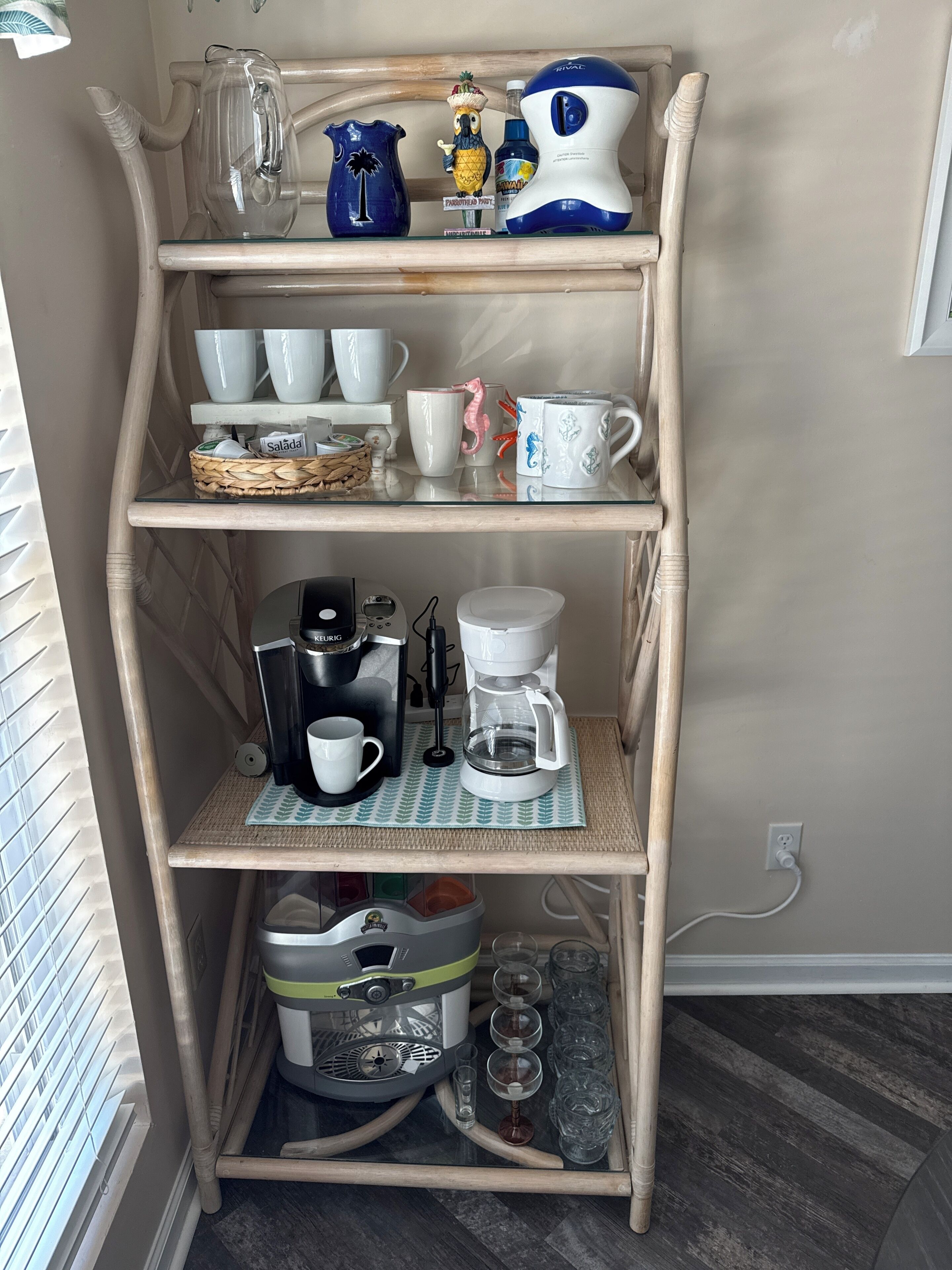 A wooden shelf with kitchenware, a coffee maker, and a decorative item.