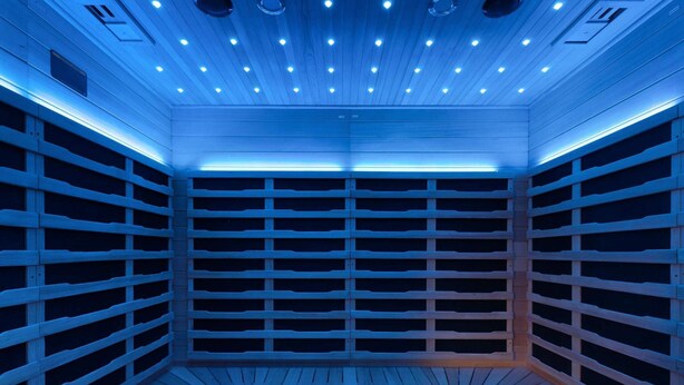 A sauna with a wooden interior, multiple benches, and a ceiling with evenly spaced lights. - 20 Person Holiday Home in Skaerbaek (Skaerbaek)
