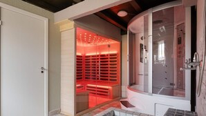 A modern bathroom with a walk-in shower, a glass-enclosed sauna, and a tiled floor. - 20 Person Holiday Home in Skaerbaek (Skaerbaek)
