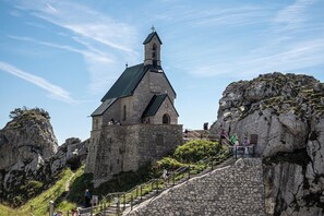 A stone church with a steep stone staircase leading up to it, surrounded by rocky terrain. - Alpine view at the Wendelstein apartment (Brannenburg)
