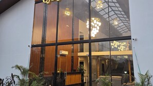A modern building with large glass windows and a sign reading 'CASA ETERNAL'.