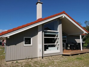 A small, single-story building with a red roof and a large window. - 4 Star Holiday Home in Grossenbrode (Grossenbrode)