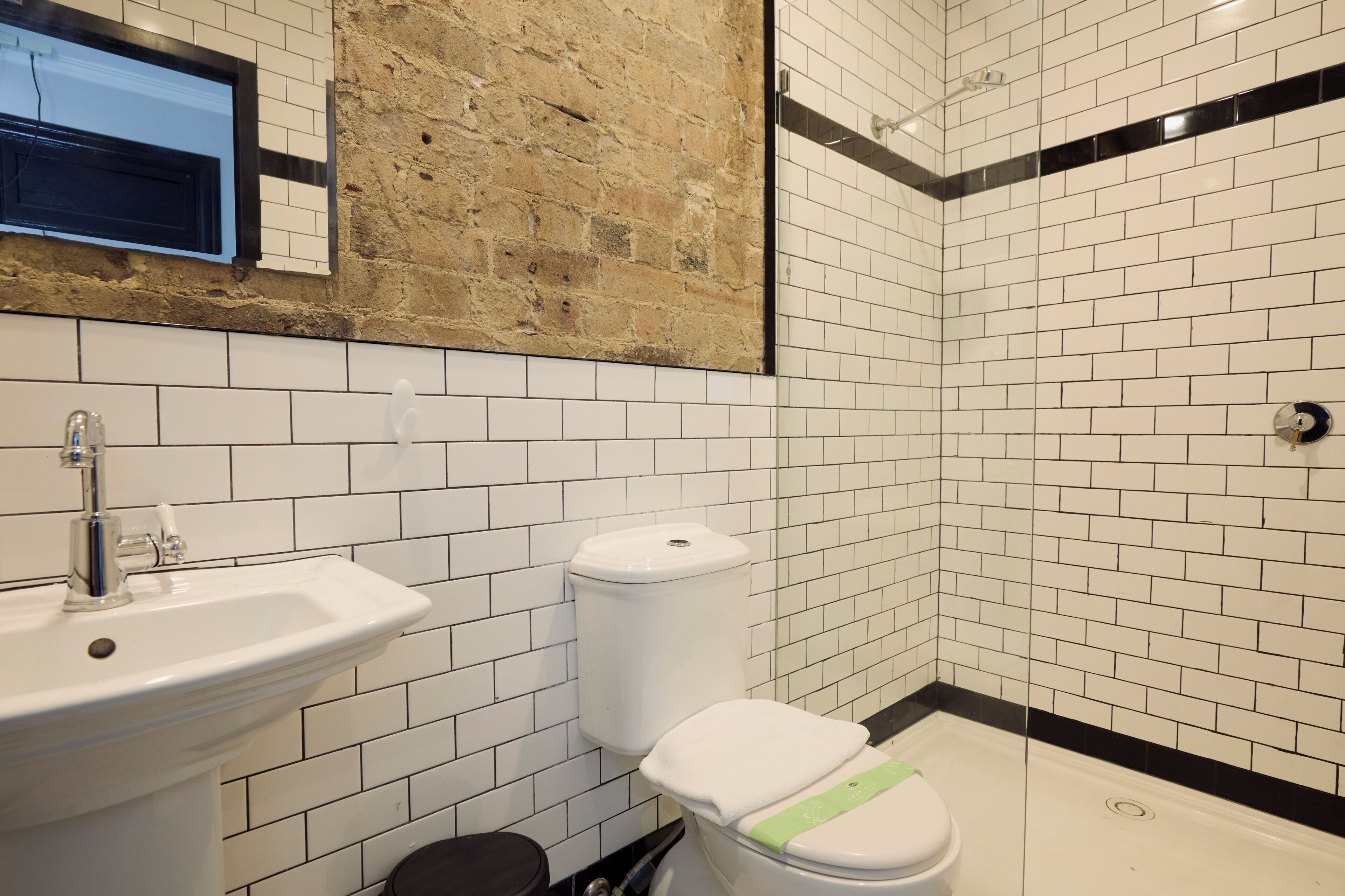 Un baño con lavamanos, inodoro y ducha.