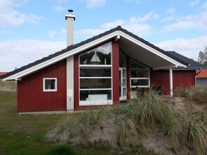 A red building with a white roof, large windows, and a chimney. - 4 Star Holiday Home in Grossenbrode (Grossenbrode)