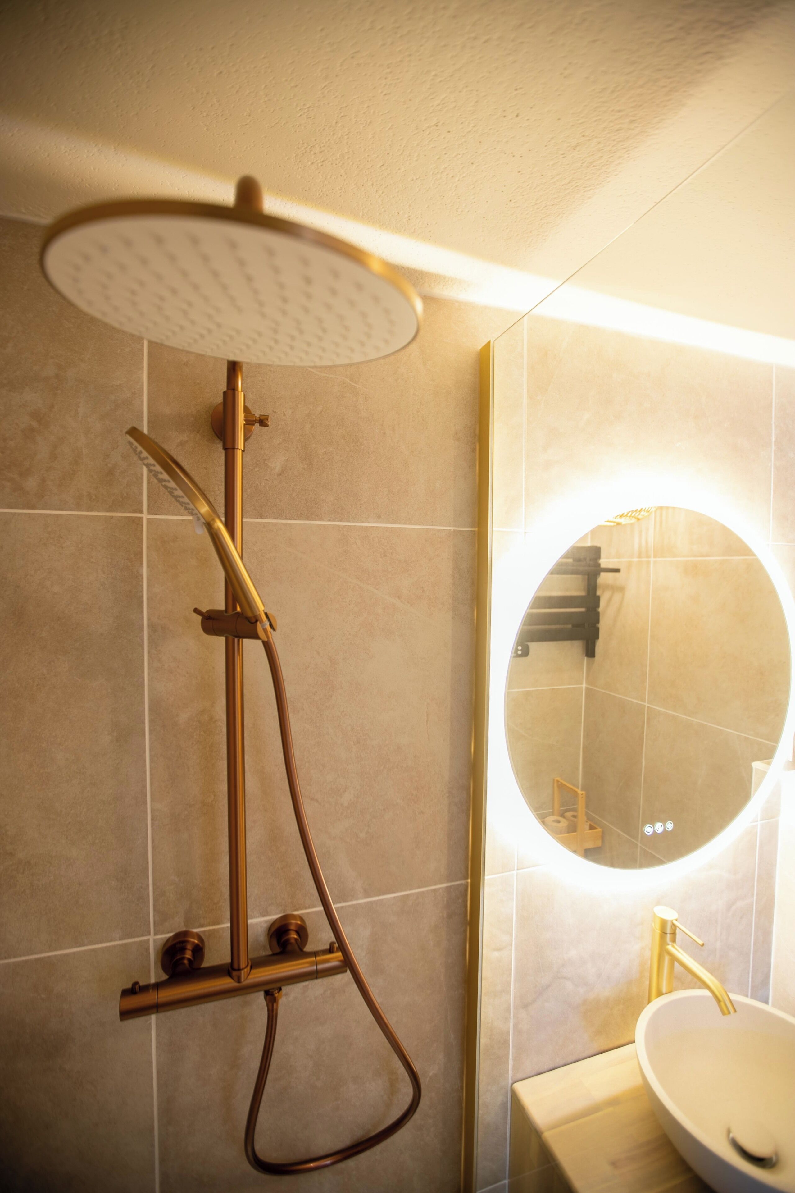 A bathroom with a shower, a sink, and a mirror.