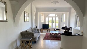 A spacious living area with a sofa, a coffee table, and a TV. - Magnificent Family Villa Near the Ceze River (Saint-Ambroix)