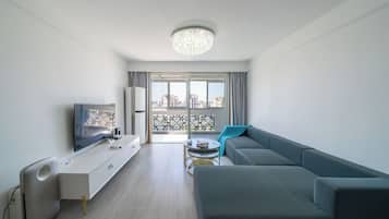 City View 3BR Serviced Residence - Ideal for Family Stay | Living room | 55-inch TV with cable channels