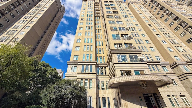A high-rise building with multiple floors, large windows, and a prominent entrance with a curved balcony. - Tyms High Serviced Residence Shanghai Caohejing (Shanghai)