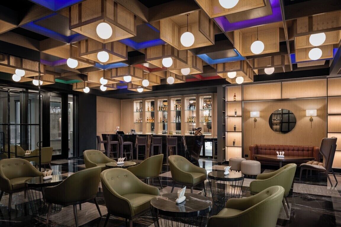 A modern bar area with seating and a bar counter.