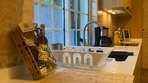 A modern kitchen with a large window, a sink, and a countertop. - Quiet house with private pool in Godinhaços, northern Portugal. (Godinhaços)