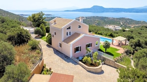 A two-story house with a swimming pool, surrounded by greenery and a view of the sea. - Villa Marathe Lux | Akrotiri, Chania | Sea Views | Private Pool (Crete)
