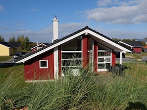 A red building with a white roof, large windows, and a chimney. - 4 Star Holiday Home in Grossenbrode (Grossenbrode)
