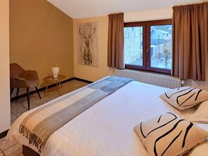A hotel room with a bed, a chair, a small table with a glass and a bottle, and a window with curtains. - Au Coeur D'alle by Belvilla-double Room (Vresse-sur-Semois)