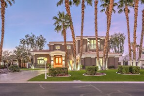 A two-story house with a well-maintained lawn, palm trees, and a driveway. - 5000sf Renovated Luxury Villa near Summerlin (Las Vegas)