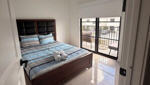 A bedroom with a bed, a window, and a view of the outside. - Spacious 4-bedroom house in wonderful Florida City with AC (Florida City)