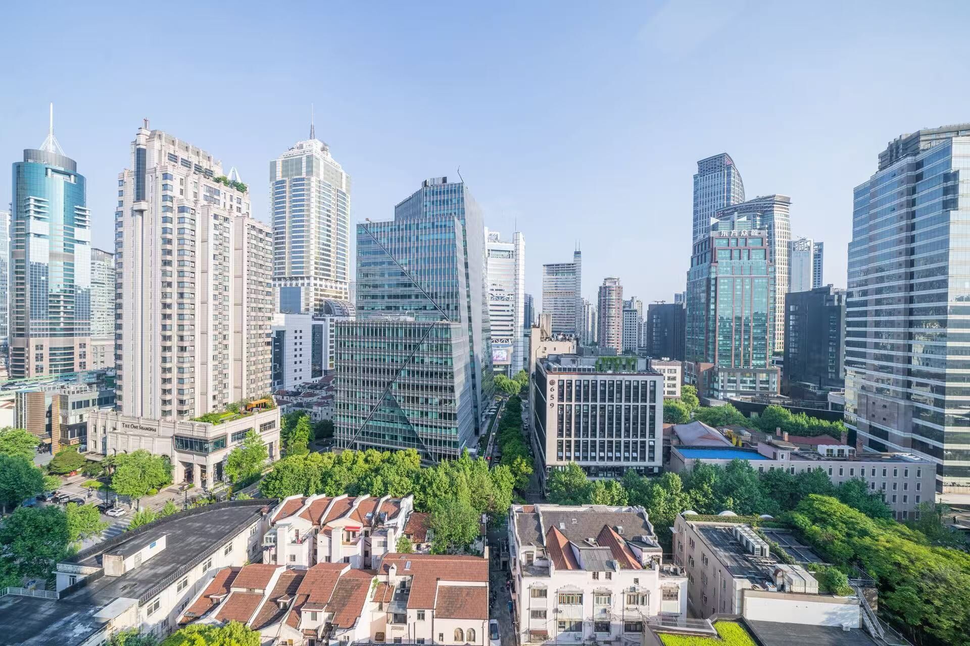 A cityscape with modern high-rise buildings, a mix of residential and commercial structures, and a central area with a grid of streets.