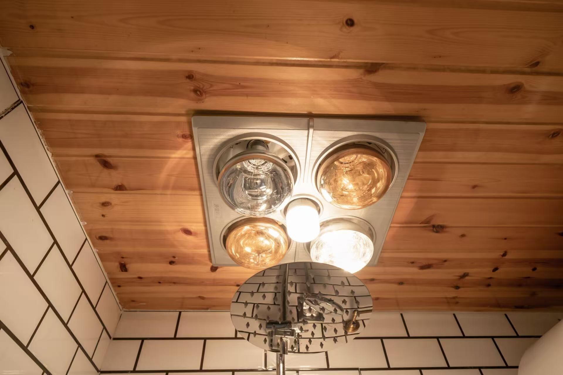 A ceiling with a unique light fixture and wooden paneling.