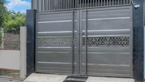 A metal security gate with a keypad lock and a small step leading up to it. - Deluxehotel Gaurav Inn (Faizabad)