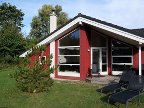 A red building with large windows and a chimney. - 4 Star Holiday Home in Grossenbrode (Grossenbrode)