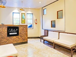A reception area with a reception desk, seating, and artwork on the walls. - Classic With Twin Bed , Pune Nagar (Pune)