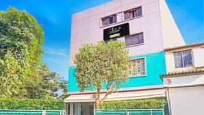 A modern building with a sign that reads 'Collection & Company-Serviced.' - Classic With Twin Bed , Pune Nagar (Pune)