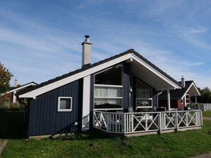 A modern house with a large deck, a chimney, and a spacious interior. - 4 Star Holiday Home in Grossenbrode (Grossenbrode)