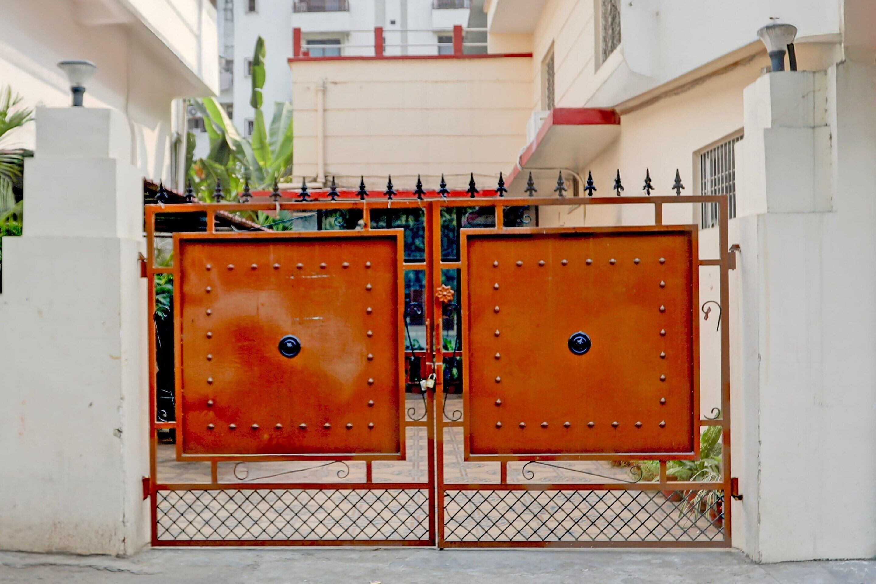 A gated entrance with a metal gate and decorative elements.