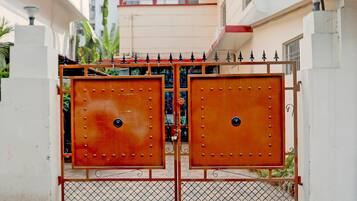 A gated entrance with a metal gate and decorative elements.