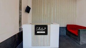 A reception desk with a sign reading 'Collection' and 'Company-Served'. - Deluxe Heritage Hotel (Prayagraj)