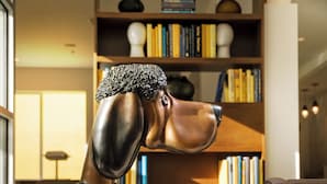A sculpture of a dog in a modern living room with a bookshelf and a sofa. - Staypineapple, Hotel Z, Gaslamp San Diego (San Diego)