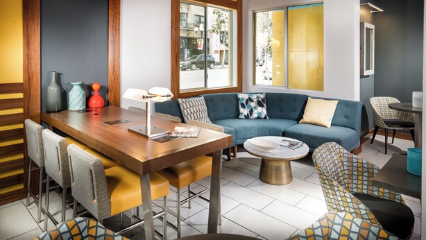 A modern living room with a sofa, dining table, chairs, and a coffee table. - Staypineapple, Hotel Z, Gaslamp San Diego (San Diego)