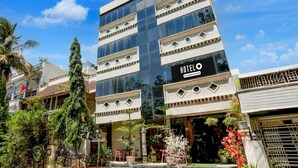 A modern hotel with a prominent 'HOTELO' sign, featuring a multi-story structure with large windows and a flat roof. - Deluxe Easy Stay (Bhopal)