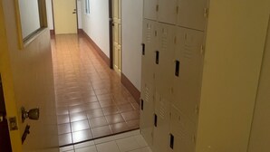 A hallway with lockers, a door labeled '401', and a tiled floor.