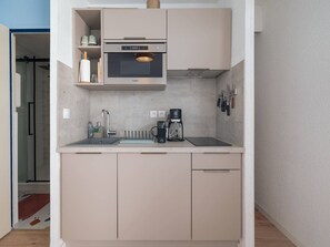A compact kitchen with a built-in microwave, a coffee maker, and a sink. - City centre apartment, pets welcome (Le Touquet-Paris-Plage)