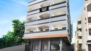 A multi-story hotel with a sign indicating it offers company services. - Deluxeorient Royale Nagpur (Nagpur)