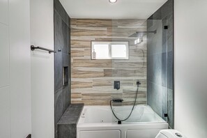 A modern bathroom with a bathtub, a shower, and a window. - Studio Tours & Universal Fun! Burbank Family Home (Burbank)