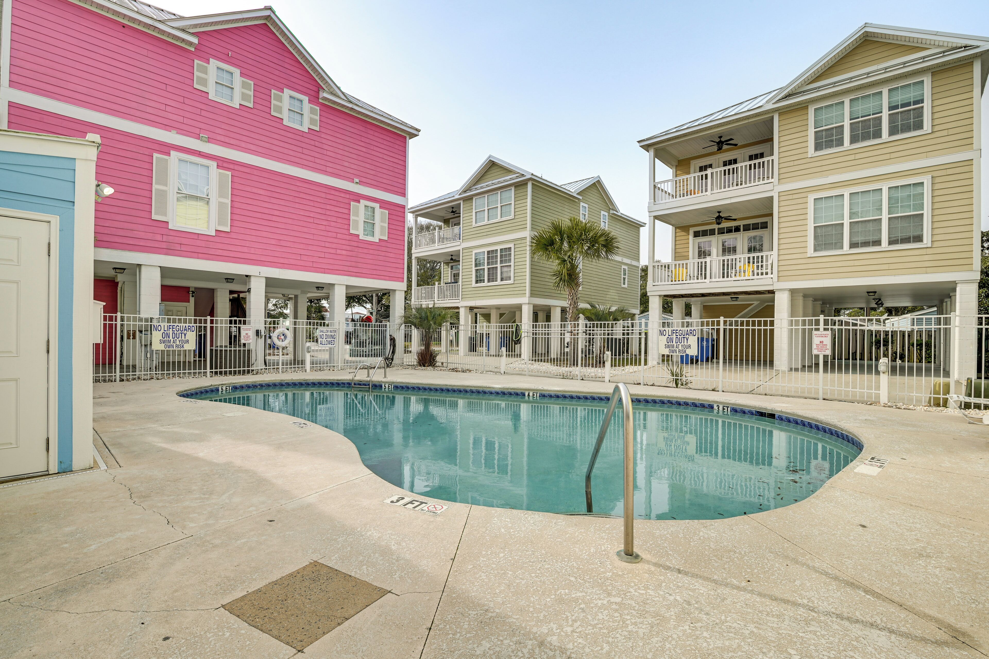 A swimming pool surrounded by multi-story residential buildings with balconies.