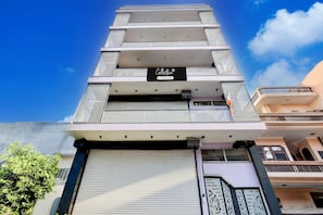 A multi-story building with a sign reading 'Collection & Company Services.' - Super Collection O Sadar Bazar Gurgaon (Gurugram)