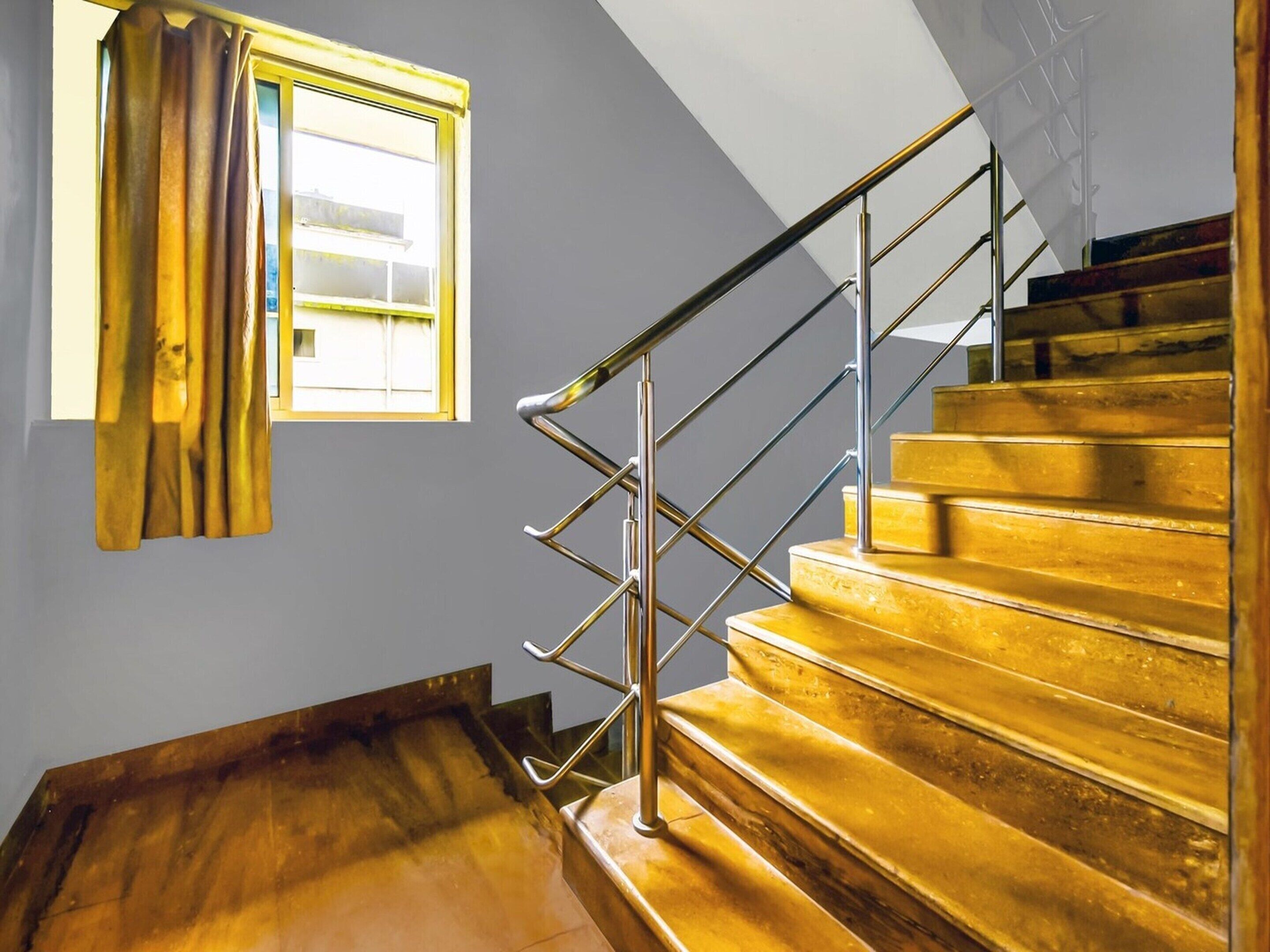 A staircase with a metal handrail and wooden steps.