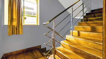 A staircase with a metal handrail and wooden steps.