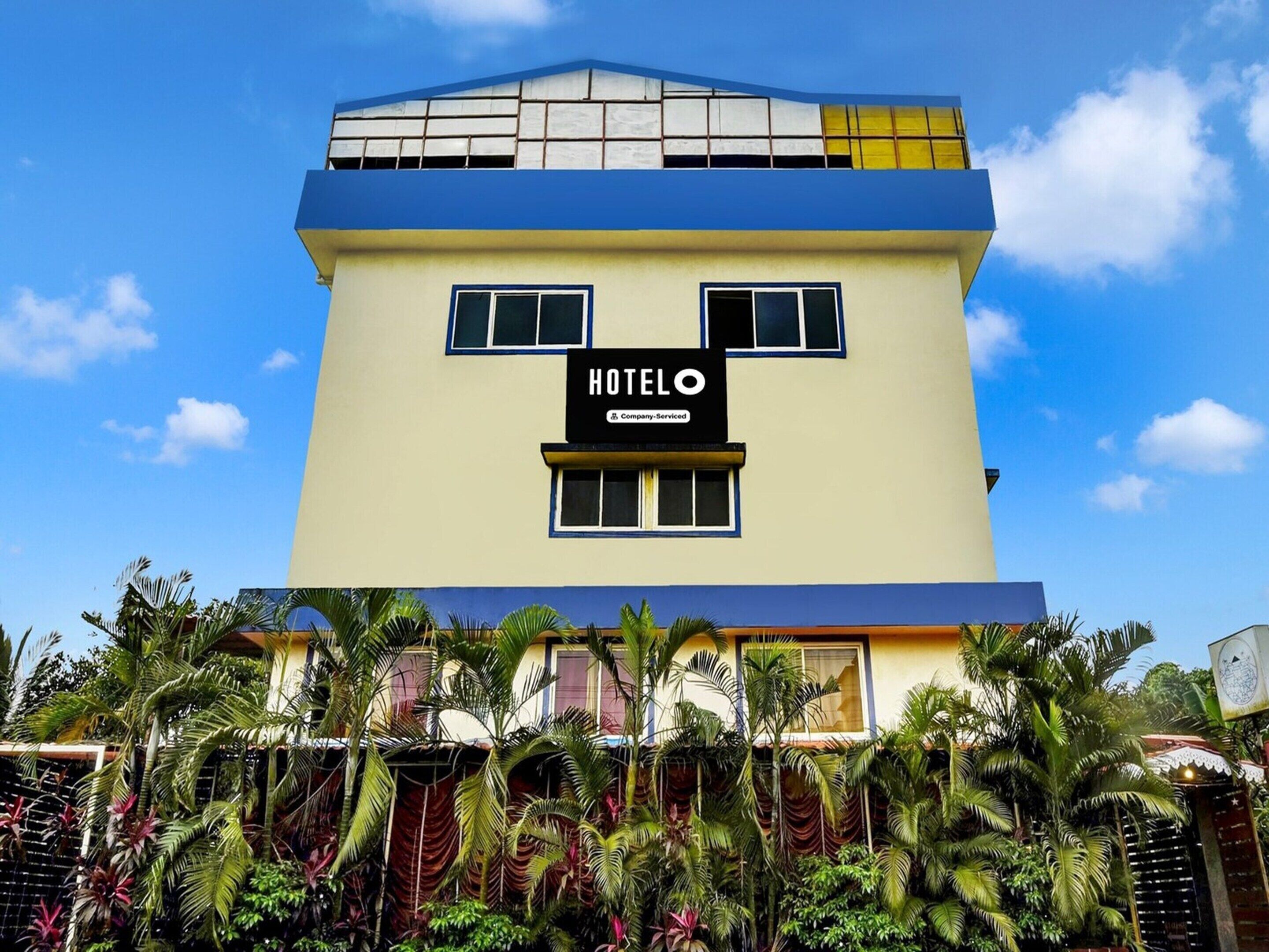 A hotel building with a sign reading 'HOTEL' and a company-serviced logo.