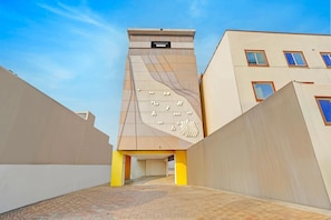 A modern building with a unique architectural design, featuring a central tower and multiple windows. - Deluxe Townhouse Arulmigu Devi Temple Chennai (Chennai)