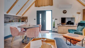 A modern loft apartment with a dining area, kitchen, and living space. - Plitvice Nature Resort (Plitvička Jezera)