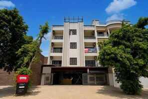 A multi-story hotel with a reception area and rooms.