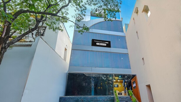 A modern building with a sign indicating it is serviced by OYO.