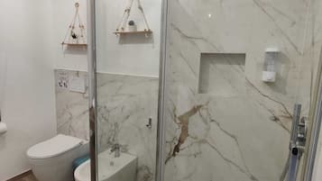 Suite, Garden View | Bathroom | Shower, hair dryer, towels, soap