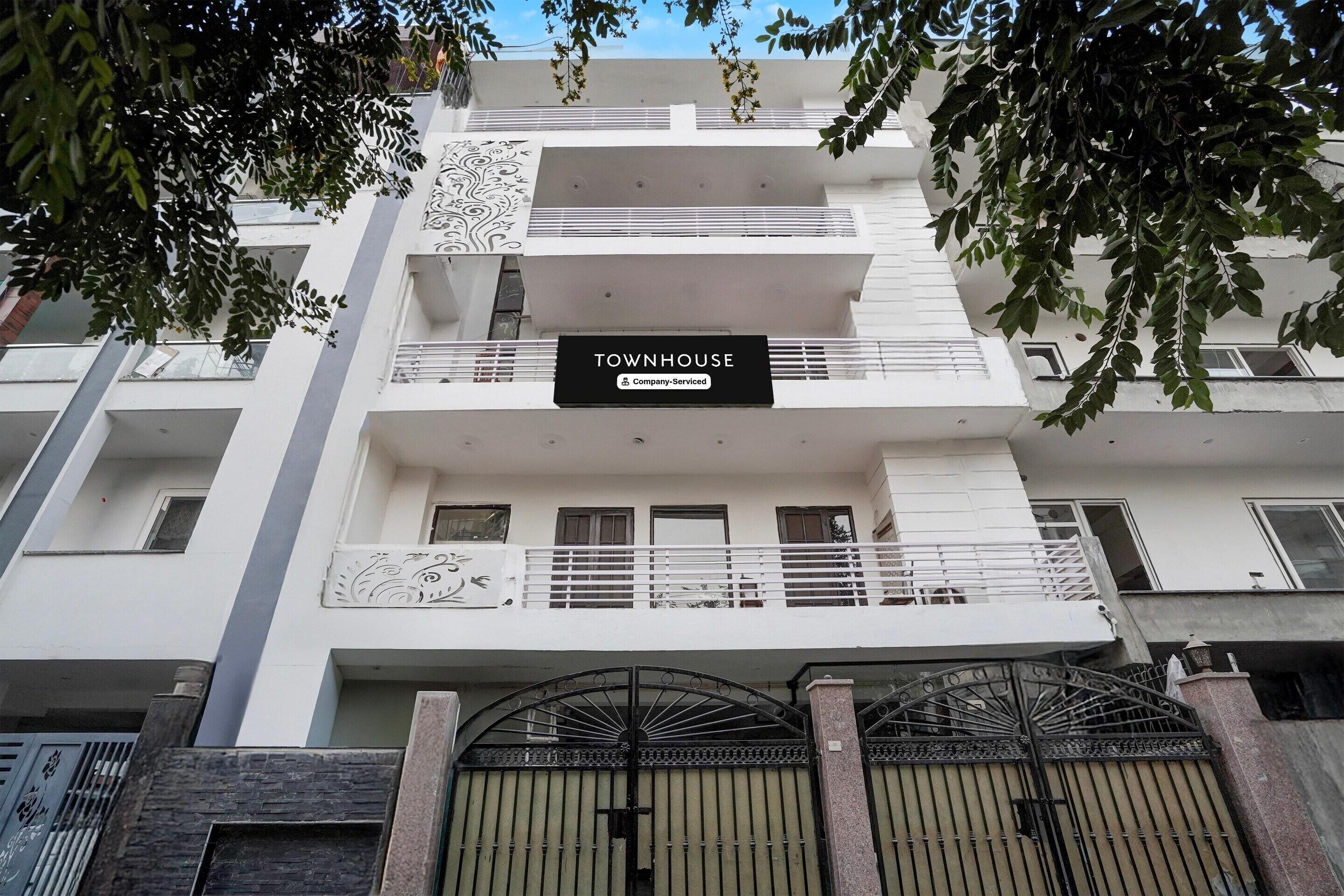 A multi-story building with a sign reading 'TOWNHOUSE.'